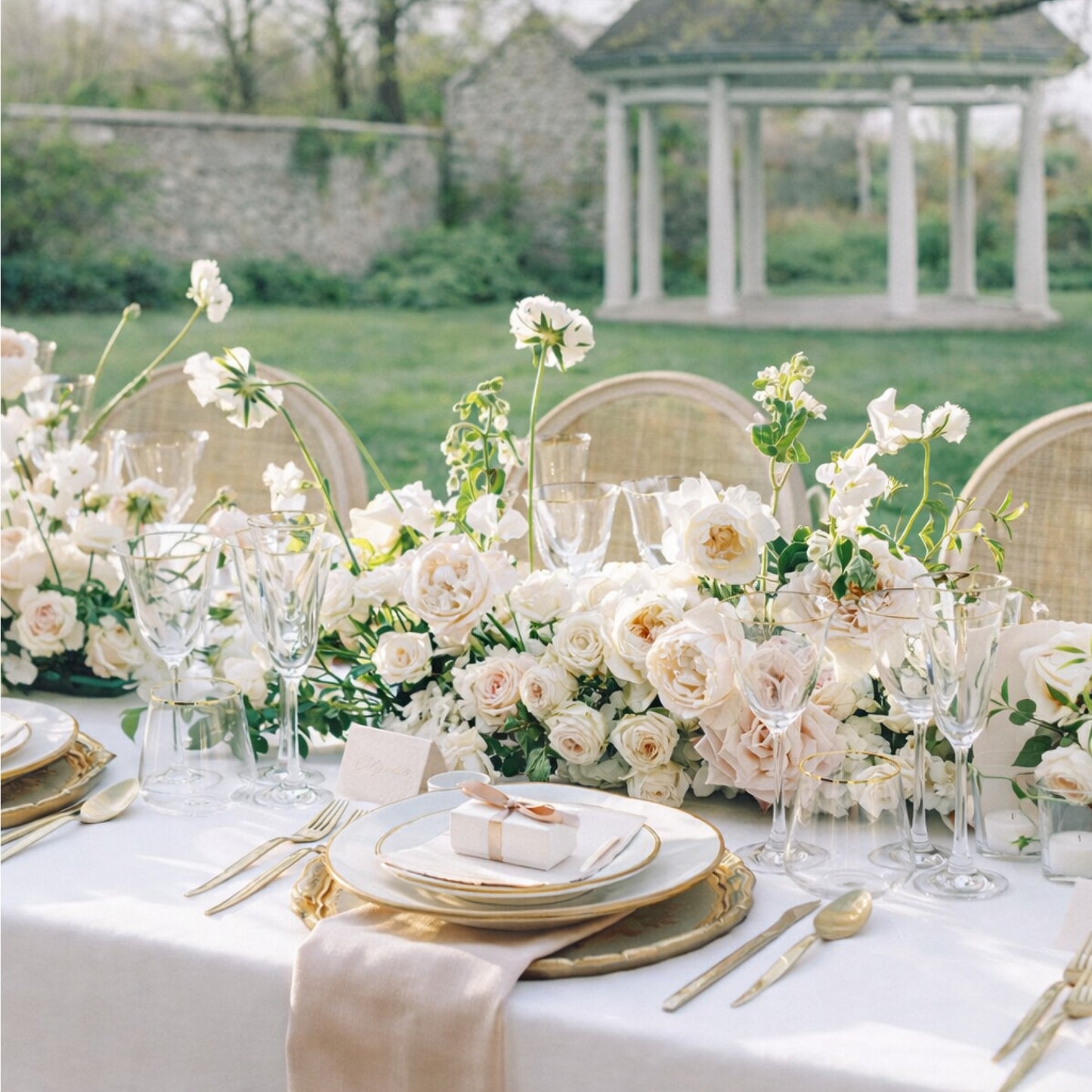 Rosewater growing garden runner extending across a romantic reception table with layered blush and ivory blooms.