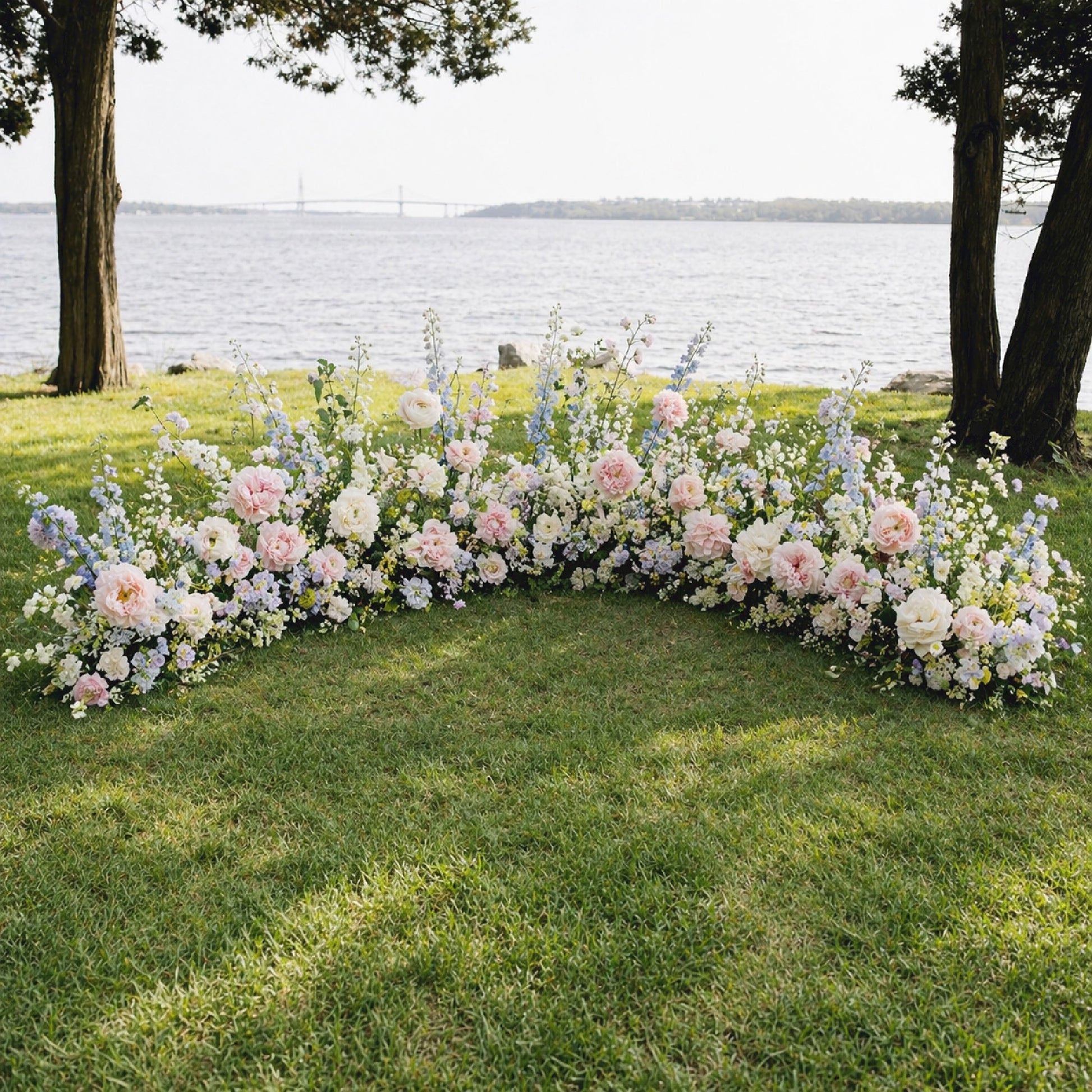 Pastel ground meadow flowers framing romantic outdoor wedding ceremony
