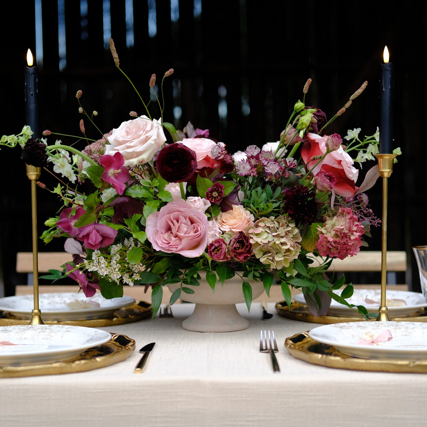 Moody heirloom compote wedding centerpiece with burgundy, mauve, blush, and autumn florals