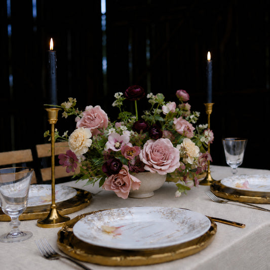 Side view of moody still-life wedding centerpiece in sculptural ceramic vessel