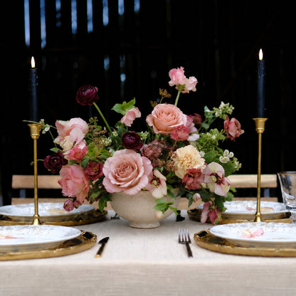 Large moody still-life wedding centerpiece with burgundy, mauve, blush, and autumn florals