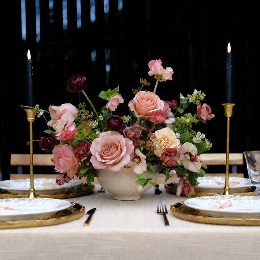 Large moody still-life wedding centerpiece with burgundy, mauve, blush, and autumn florals