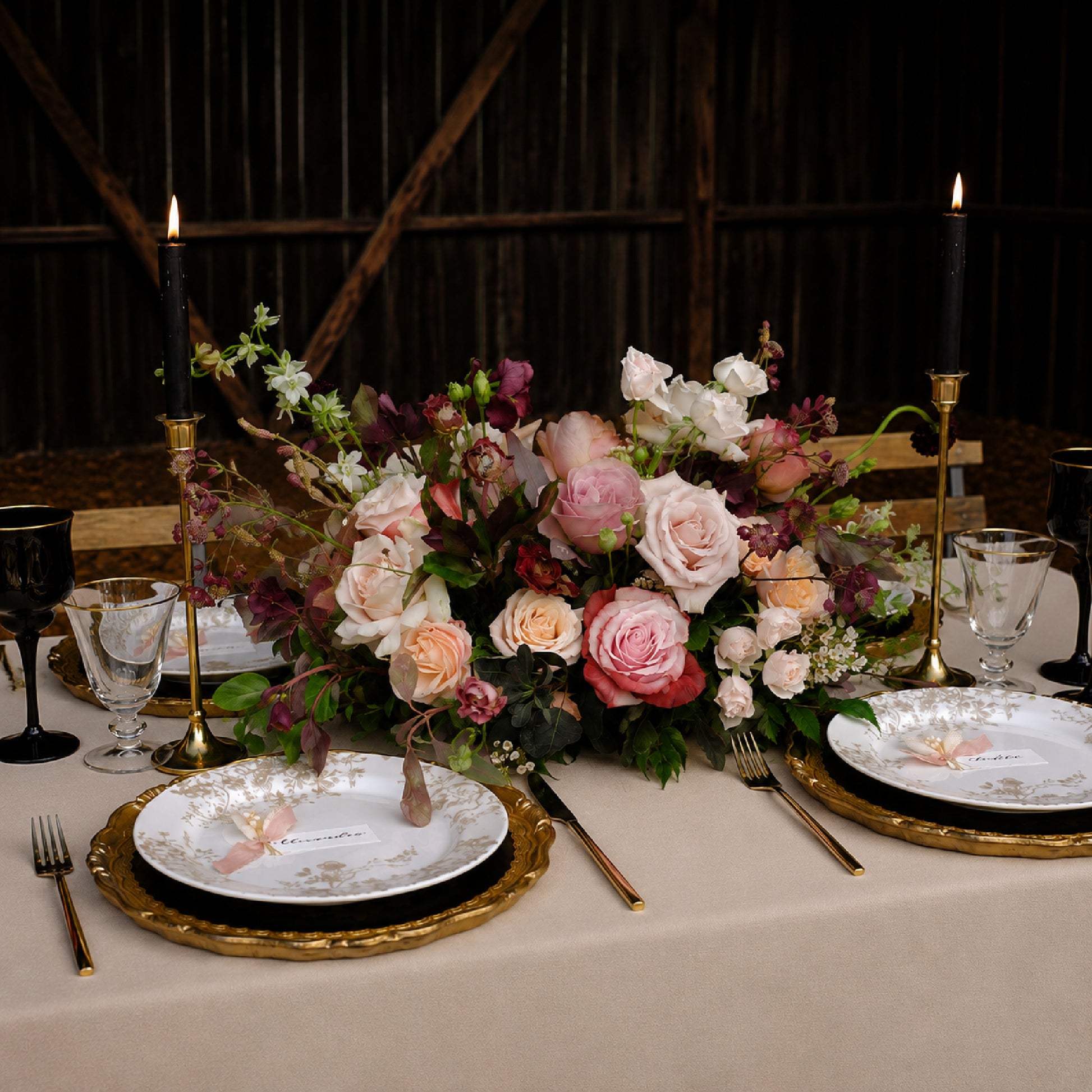 Side view of moody meadow-style wedding arrangement with burgundy, mauve, and autumn garden florals