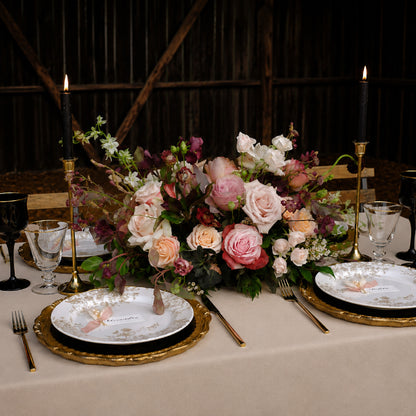 Side view of moody meadow-style wedding arrangement with burgundy, mauve, and autumn garden florals