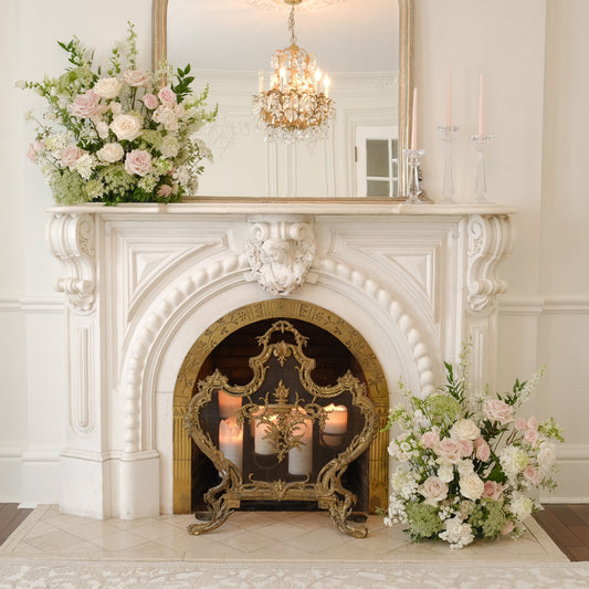 Rosewater meadow arrangements with blush and ivory garden blooms styled beside an elegant fireplace mantel.