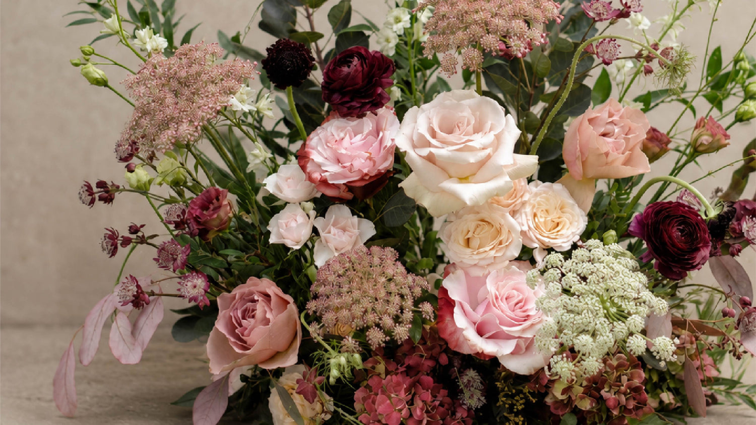Close-up of a romantic wedding floral meadow arrangement with layered seasonal blooms and natural garden-style movement by Redolence.